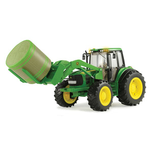 Tractor holding haybale on forks