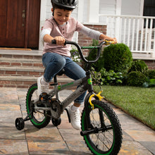Load image into Gallery viewer, Boy riding bike with helmet on
