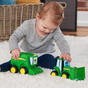 Baby playing with tractor and combine
