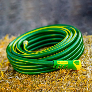 Rolled up hose sitting on hay bale