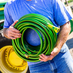 Man holding rolled up hose