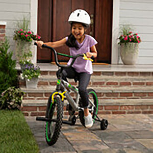 Girl riding bike with helmet on